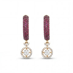 Elegant 18KT gold drop earrings featuring ruby pavé hoops with diamond halo circle drops on a white background.