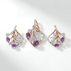 Graceful 18KT rose gold pendant set featuring natural oval amethyst gemstones and brilliant round diamonds in an elegant open floral vine design. The set includes a matching pendant and a pair of earrings with sparkling diamond accents, creating a sophisticated blend of color and contemporary craftsmanship.