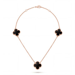 Elegant 18KT rose gold necklace featuring three black clover motifs on a delicate chain with a polished finish on a white background.
