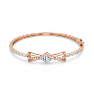 Beautiful 18KT rose gold bangle showcasing slim diamond-set bands with an intricate bow centerpiece on a white background.