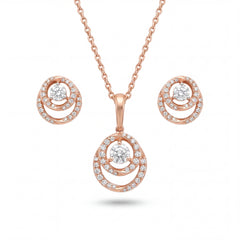 Beautiful 18KT rose gold jewelry set showcasing round layered pendants with sparkling center diamonds and coordinated earrings on a white background.