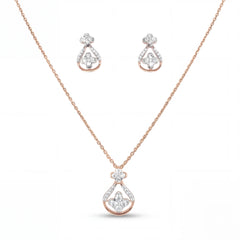 Beautiful 18KT rose gold necklace set showcasing teardrop-inspired diamond pendant and matching earrings with floral accents on a white background.