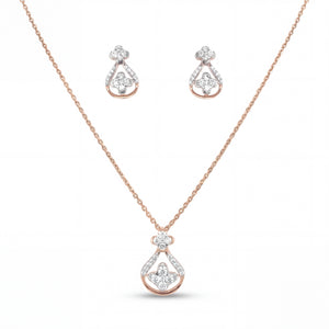 Beautiful 18KT rose gold necklace set showcasing teardrop-inspired diamond pendant and matching earrings with floral accents on a white background.