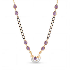 Elegant 18K gold mangalsutra necklace featuring pear-shaped purple gemstones, dual black bead chains, and a diamond-accented pendant on a white background by Pachchigar Jewellers Ashokbhai.