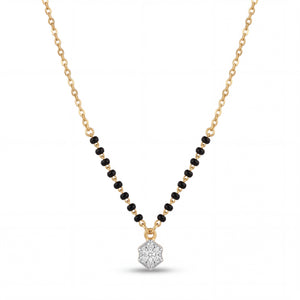 Elegant 18K gold mangalsutra necklace featuring black bead detailing and a sparkling diamond cluster pendant on a white background by Pachchigar Jewellers Ashokbhai.