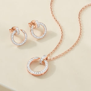 Luxurious 18K rose gold diamond minimal jewelry set featuring modern open circle pendant necklace with matching diamond hoop earrings by Pachchigar Jewellers Ashokbhai