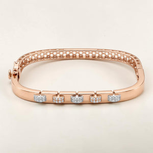 Elegant 18K rose gold designer kada featuring five floating diamond charm motifs with alternating pavΓ©-set and textured finishes. Contemporary luxury bracelet by Pachchigar Jewellers.