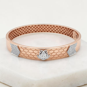 Elegant 18K rose gold diamond kada featuring a honeycomb pattern, white gold Lord Ganesh motif, and sparkling diamond accents. A luxurious designer bracelet by Pachchigar Jewellers.