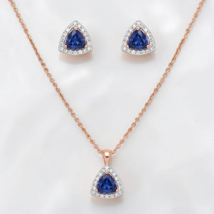 Luxurious 18K rose gold sapphire diamond jewelry set featuring triangle blue sapphire pendant with matching halo earrings and fine chain by Pachchigar Jewellers Ashokbhai