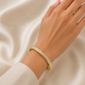 Elegant 18K yellow gold designer bangle featuring dual parallel rows of pavΓ©-set brilliant diamonds, a sleek polished profile, and a refined contemporary silhouette. Luxury diamond bracelet by Pachchigar Jewellers.