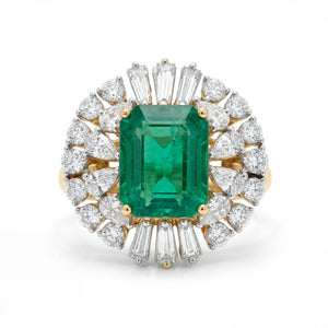 Elegant 18K yellow gold emerald diamond halo statement ring featuring emerald cut center emerald with pear and baguette cut diamond surround by Pachchigar Jewellers Ashokbhai