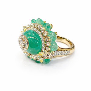 Luxurious 18K yellow gold emerald diamond lotus statement ring featuring oval cabochon emerald center, diamond halo and emerald bead floral surround by Pachchigar Jewellers Ashokbhai