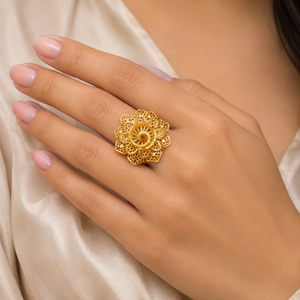 Exquisite 18K yellow gold statement ring featuring an intricate floral filigree design with handcrafted openwork petals, a radiant sunburst-inspired center, and traditional heritage craftsmanship. Luxury designer gold ring by Pachchigar Jewellers.