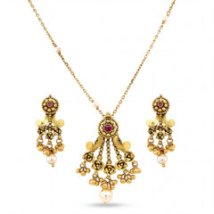 Graceful 22KT yellow gold pendant set featuring antique-style pendant with ruby accents, floral detailing, pearl drops, and matching dangling earrings on a white background.