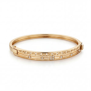 Elegant 22KT gold kada bracelet featuring delicate diamond accents with openwork detailing on a white background.