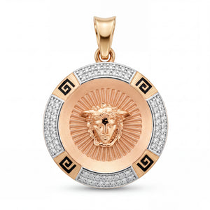 Luxury 22KT gold round pendant featuring a Medusa-inspired face motif, radiant engraved center, diamond-studded outer ring, and black Greek key accents on a white background.