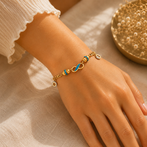 Elegant 22KT yellow gold bracelet featuring a turquoise enamel infinity-inspired centerpiece with evil eye charm accents and a stylish curb chain, beautifully worn on a woman's wrist, perfect for everyday wear, gifting, and symbolic protection.