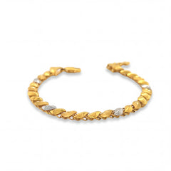 Elegant 22KT gold bracelet featuring alternating leaf-shaped links with white gold accents on a white background.