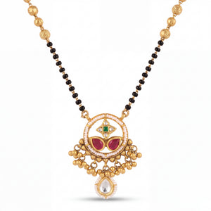 Traditional mangalsutra featuring black bead strands, handcrafted gold chain, designer pendant with ruby, emerald, pearl detailing, dangling gold charms, and festive ethnic styling for bridal and special occasions.