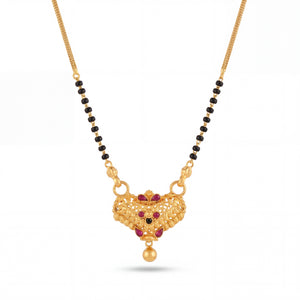 Traditional mangalsutra featuring black bead strands, handcrafted gold chain, ornate designer pendant with red stone embellishments, filigree detailing, and timeless ethnic styling for festive and bridal wear.