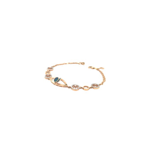 Stylish rose gold bracelet featuring an evil eye centerpiece with blue opal accents and sparkling circular diamond motifs on a delicate chain with adjustable clasp.