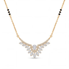 Elegant gold mangalsutra necklace featuring black beads and a dazzling diamond leaf wing pendant with a central emerald-cut diamond on a white background.