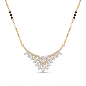 Elegant gold mangalsutra necklace featuring black beads and a dazzling diamond leaf wing pendant with a central emerald-cut diamond on a white background.