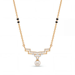 Elegant gold mangalsutra necklace featuring black beads, sparkling diamond accents, and a classic pearl drop pendant on a white background.