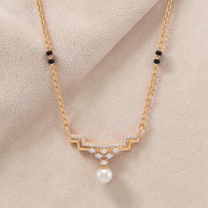 Elegant gold mangalsutra necklace featuring black beads, sparkling diamond accents, and a classic pearl drop pendant on a white background.