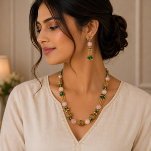 Traditional gold jewellery set featuring pink gemstone beads, green bead accents, ornate gold elements, and matching long drop earrings with delicate bead detailing.