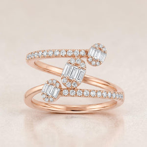 Rose gold wrap-style ring featuring three oval diamond clusters with baguette-cut centers, accented by pavé-set diamonds along the crisscross band for a contemporary and elegant look.