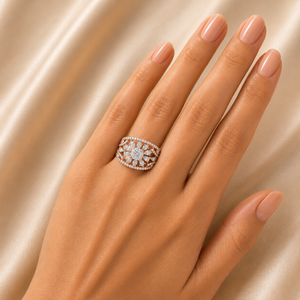 Elegant gold ring featuring an oval diamond-set design with a prominent round center diamond, surrounded by intricate floral-inspired openwork and a sparkling diamond border.