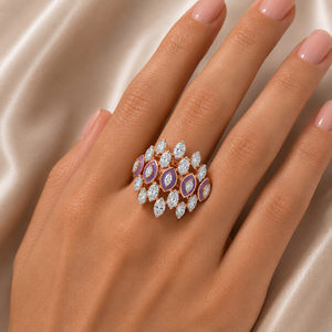 Statement gold ring featuring multiple oval purple gemstones framed with halos of sparkling diamonds and surrounded by marquise-cut diamond accents in an intricate clustered design.