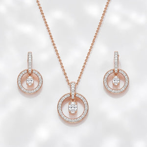Elegant rose gold diamond jewelry set featuring a circular pendant necklace with matching dangling circle earrings on a white background.