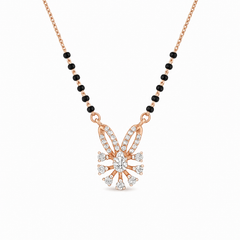 Elegant rose gold mangalsutra necklace featuring black beads and a sparkling floral-inspired diamond drop pendant with intricate detailing on a white background.