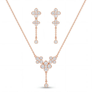 Elegant rose gold diamond jewelry set featuring a floral drop pendant necklace with matching dangling floral earrings on a white background.