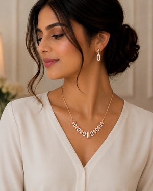 Elegant rose gold jewellery set featuring a delicate necklace with multiple oval and loop-shaped diamond accents, paired with matching diamond drop earrings.