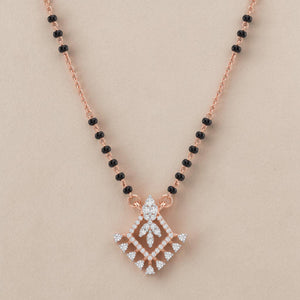 Elegant rose gold mangalsutra necklace featuring black beads and a royal-inspired diamond drop pendant with intricate sparkling detailing on a white background.