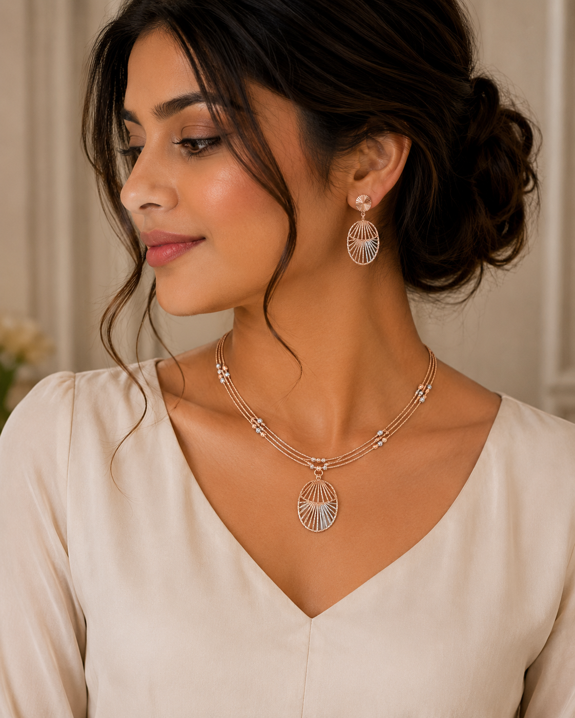 Elegant rose gold jewellery set featuring a delicate layered necklace with a fan-shaped openwork pendant and matching fan-inspired drop earrings, accented with sparkling diamonds.