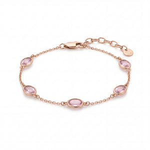 Elegant rose gold bracelet featuring oval pink gemstones spaced along a delicate chain with an adjustable clasp on a white background.