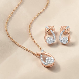 Luxurious 18K rose gold diamond minimal jewelry set featuring contemporary teardrop pendant necklace with matching stud earrings and round brilliant diamonds by Pachchigar Jewellers Ashokbhai