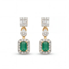 Elegant 18KT gold drop earrings featuring emerald-cut green gemstones with diamond halos and baguette diamond tops on a white background.
