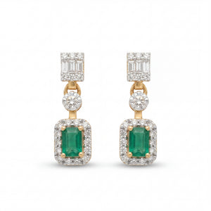 Elegant 18KT gold drop earrings featuring emerald-cut green gemstones with diamond halos and baguette diamond tops on a white background.