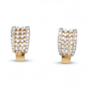 Luxurious 18KT gold earrings featuring modern openwork hoops adorned with brilliant diamonds and sleek contemporary styling on a white background.