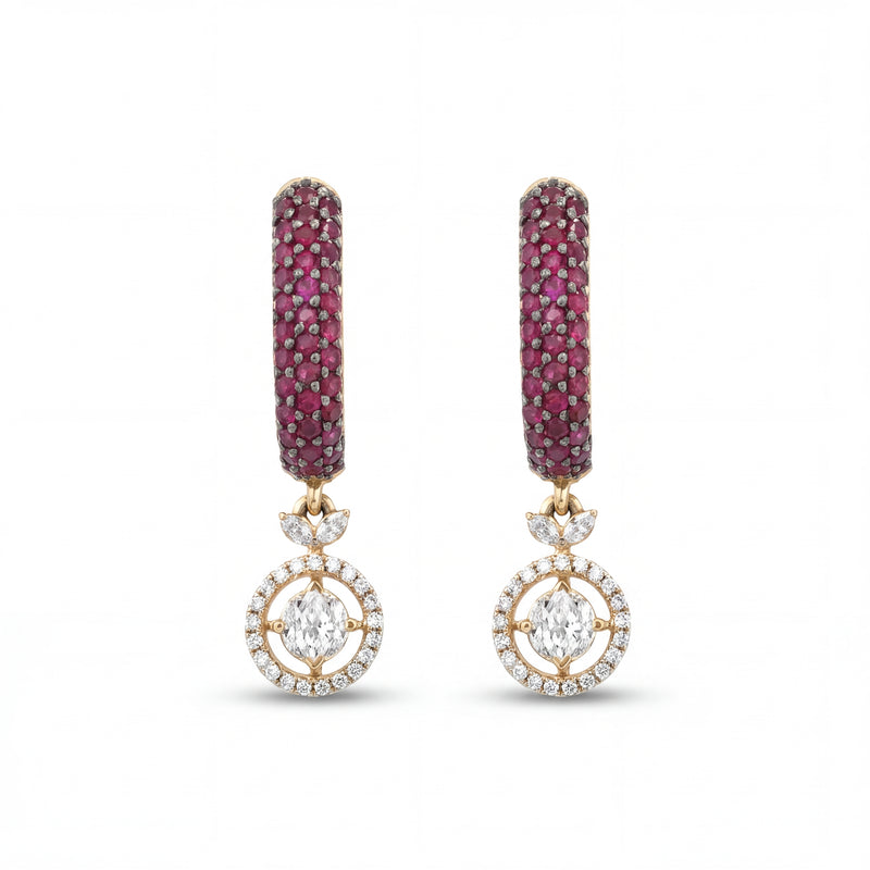 Elegant 18KT gold drop earrings featuring ruby pavé hoops with diamond halo circle drops on a white background.
