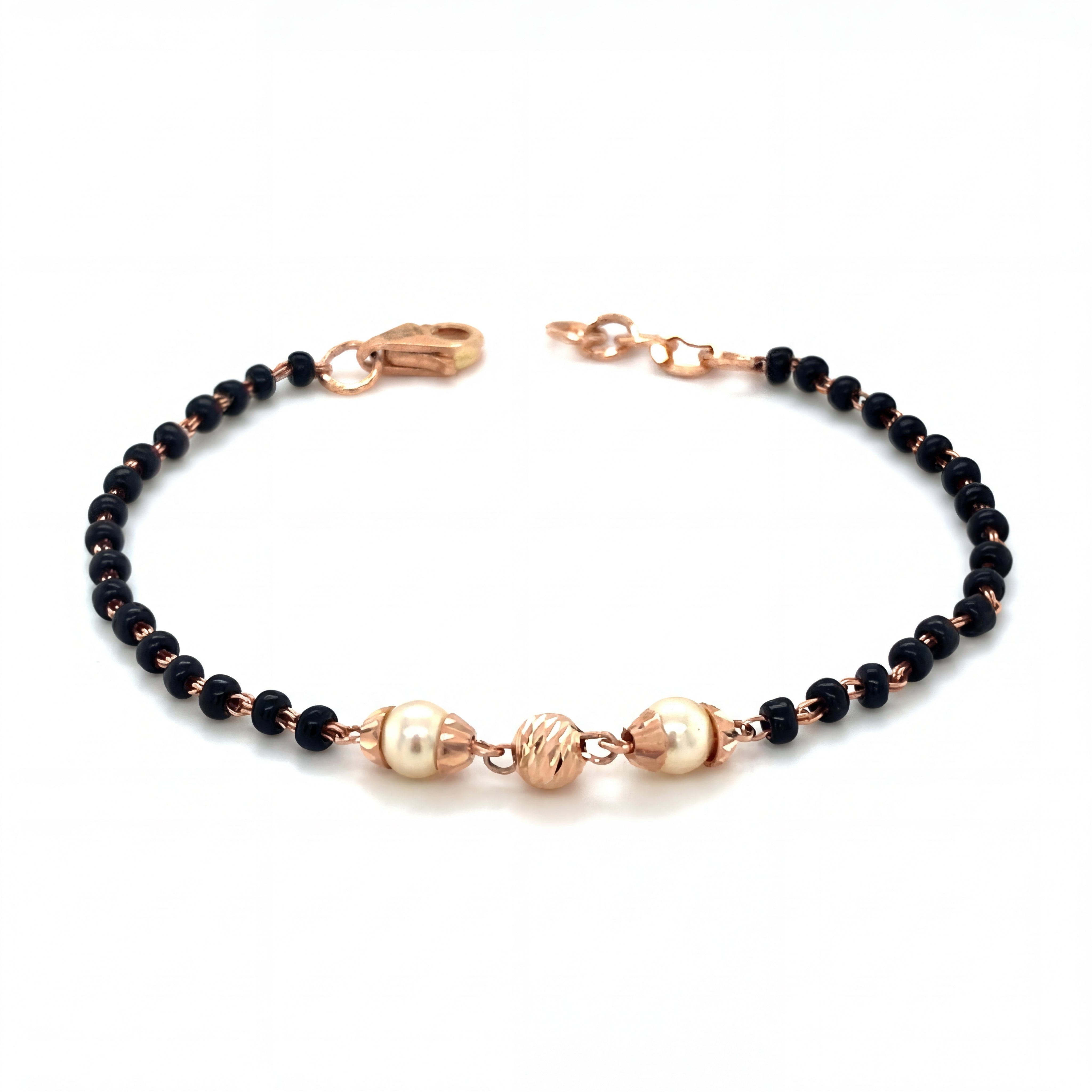 Elegant 18KT rose gold bracelet featuring black beads with pearl accents and textured gold centerpiece on a white background.