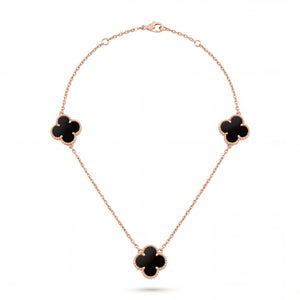 Elegant 18KT rose gold necklace featuring three black clover motifs on a delicate chain with a polished finish on a white background.