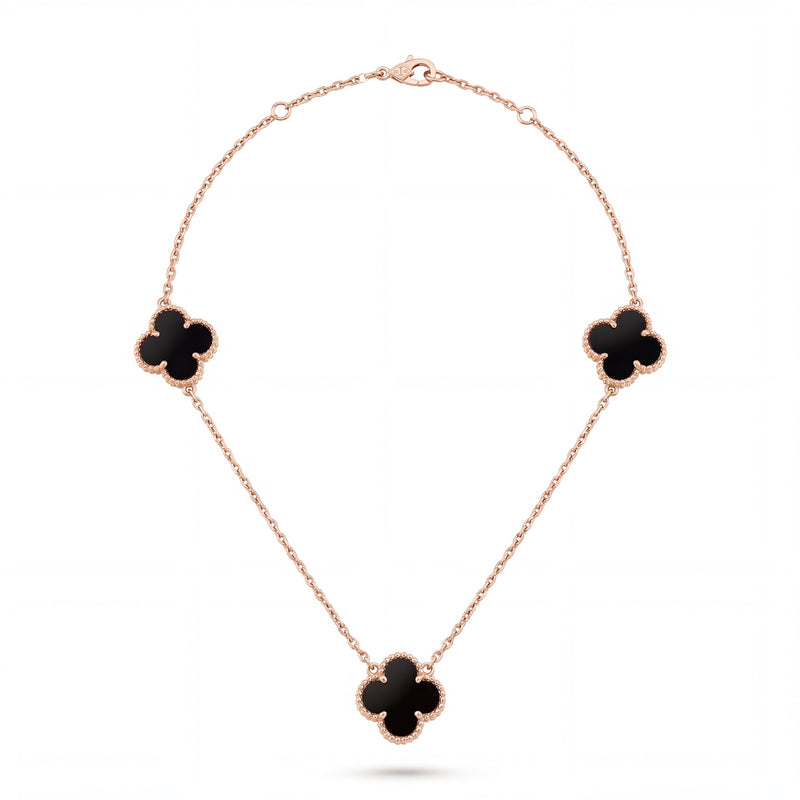 Elegant 18KT rose gold necklace featuring three black clover motifs on a delicate chain with a polished finish on a white background.