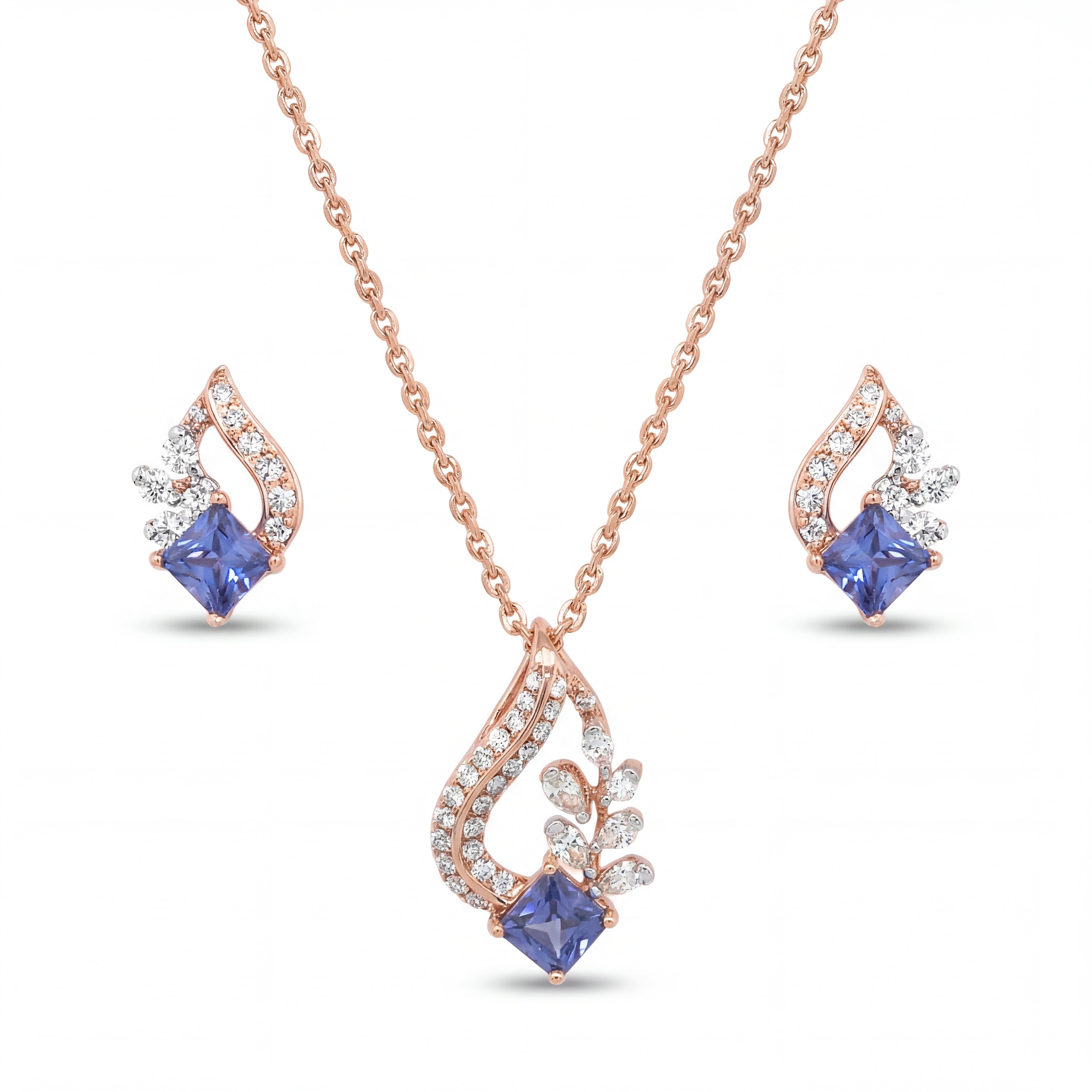 Elegant 18KT rose gold pendant set featuring blue princess-cut gemstone pendant with diamond accents and matching earrings on a white background.