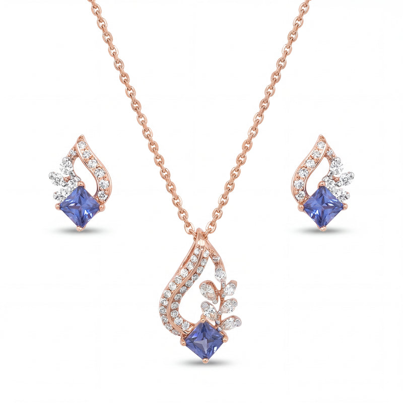 Elegant 18KT rose gold pendant set featuring blue princess-cut gemstone pendant with diamond accents and matching earrings on a white background.